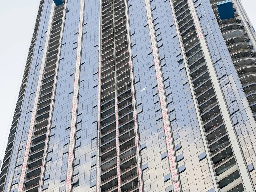 Glass residential tower under construction, the kind of off-plan project a launch campaign promotes