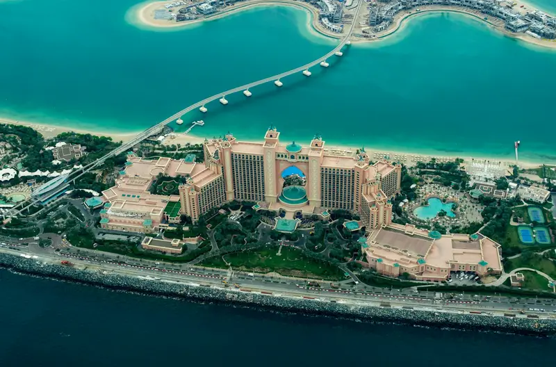 Aerial view of Palm Jumeirah in Dubai, one of the communities real estate websites build guide pages for