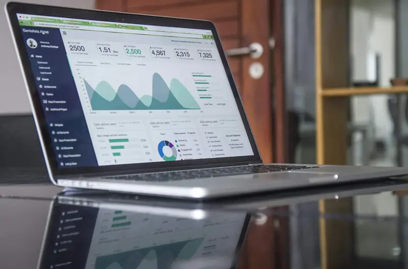 Laptop showing an analytics dashboard, like the monthly SEO reports real estate clients receive